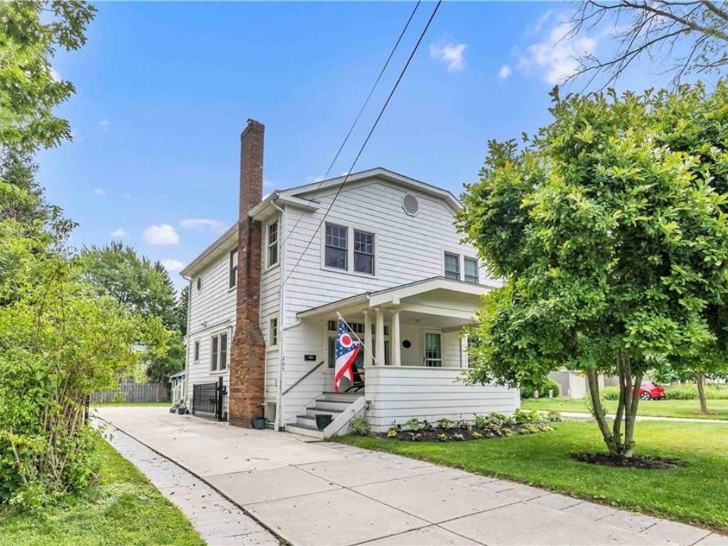 Charming house with a flag and greenery